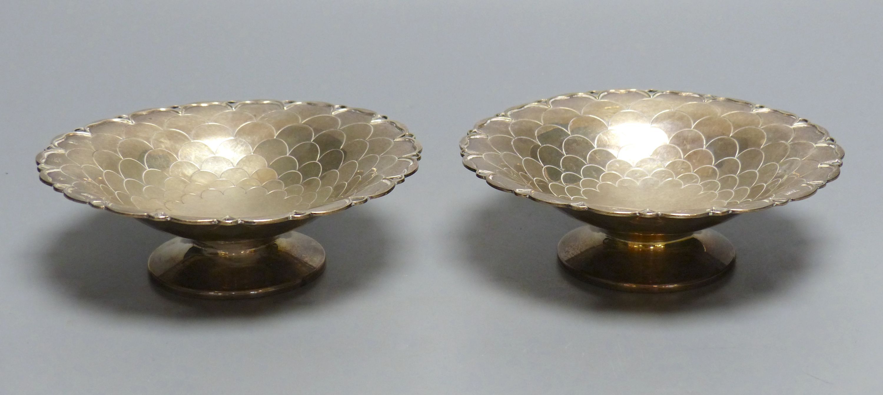 A pair of circular silver sweetmeat tazzas each having scale decoration, shaped rim and circular foot, Sheffield 1957, 15.4cm,